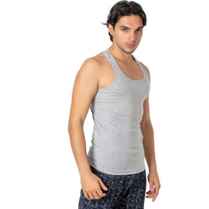 May include: A grey sleeveless undershirt with a scoop neck.