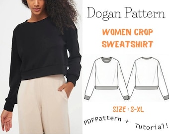 Peut inclure: Un sweat-shirt noir à manches longues et à col rond, coupé à la taille. L'image montre également un dessin au trait du sweat-shirt en blanc avec un ourlet gris, ainsi que le texte "Dogan Pattern Women Crop Sweatshirt Size: S-XL PDF Pattern + Tutorial!"