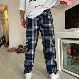 May include: Blue and white plaid pants with a black and white graphic t-shirt that says "Represent by Human" and "1876 * 2345".