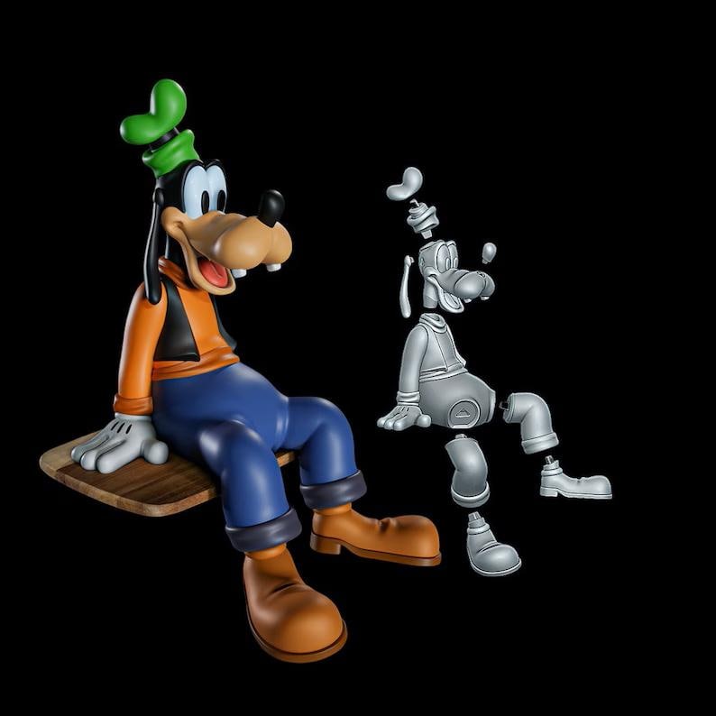 May include: A colorful figurine of Goofy, a cartoon dog, sitting on a wooden plank. He wears a green hat, orange shirt, blue pants, and brown shoes. A gray, disassembled model of Goofy is next to the figurine.