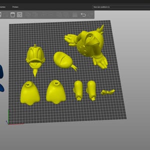 Puede incluir: Un modelo 3D de un pato de dibujos animados amarillo, dividido en piezas separadas para impresi&oacute;n 3D. Las piezas incluyen la cabeza, el cuerpo, las alas y los pies. El modelo est&aacute; listo para ser impreso y ensamblado.