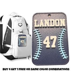 May include: White baseball backpack with a black bottom and a blue and white baseball tag with the name Landon and the number 47. The tag is attached to the backpack with a black strap. A blue and white baseball tag with the name Landon and the number 47 is attached to the backpack with a black strap.