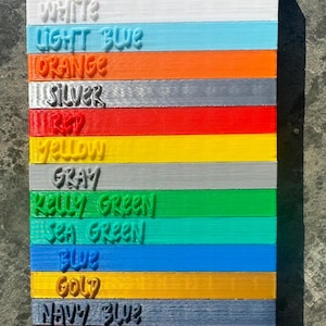 May include: A color chart with 15 different colors, including black, red burgundy, white, light blue, orange, silver, red, yellow, gray, kelly green, sea green, blue, gold, navy blue, burgundy, and purple.