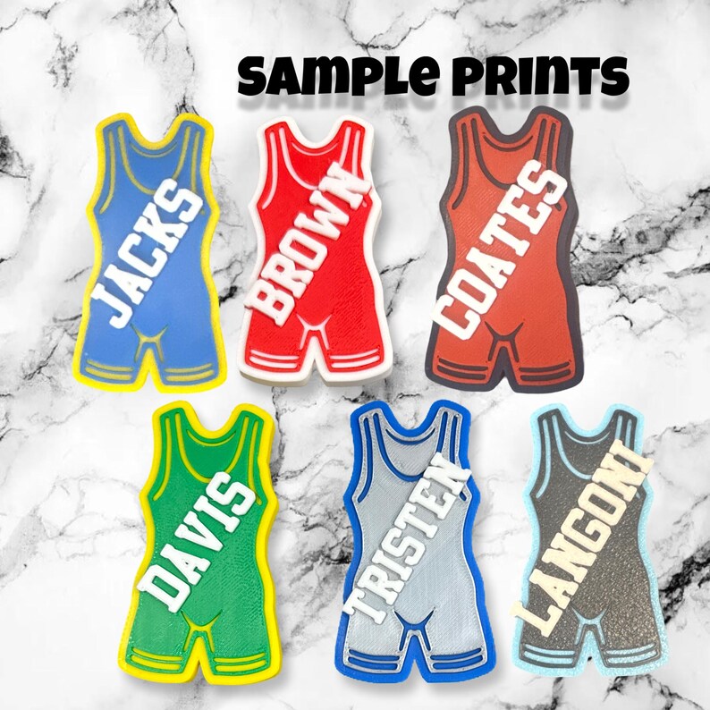 May include: Six wrestling singlets with different names printed on them. The singlets are in various colors, including blue, red, green, gray, and black.