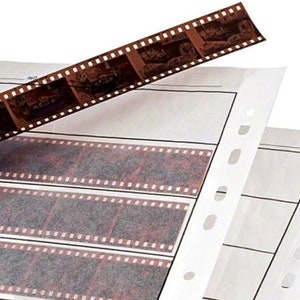 May include: A white plastic photo storage sleeve with three rows of clear plastic pockets for storing 35mm film negatives. The sleeve has holes along the edge for a binder.