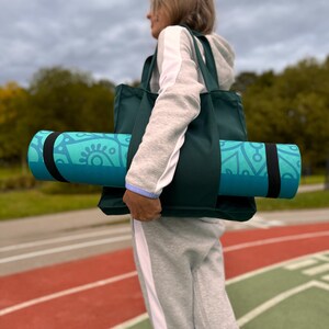 Active woman with yoga bag in the stadium.