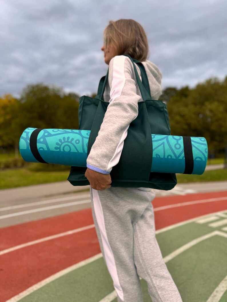 Active woman with yoga bag in the stadium.