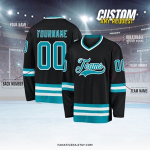 May include: Black hockey jersey with teal and white stripes. The jersey has a customizable name and number on the back, and the word "Teams" in teal on the front. The jersey is breathable and moisture-wicking.