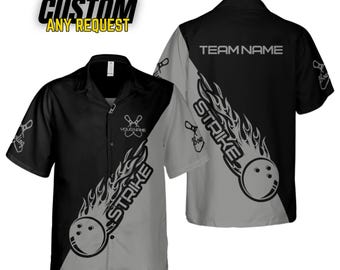 May include: Black and gray bowling shirt with a flame design and the word "STRIKE" on the front. The back of the shirt has the text "TEAM NAME".