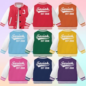 May include: Nine varsity jackets in different colors with white sleeves and a white stripe around the bottom. The back of each jacket has the name "Jasiah" and the text "EST 2018" in white.