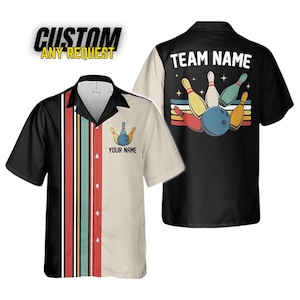 May include: Bowling shirt with a black and cream color block design. The front features a bowling pin graphic and the text "YOUR NAME". The back has a bowling ball and pins graphic with the text "TEAM NAME". The shirt has short sleeves and a button-down front.