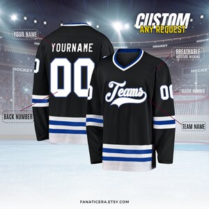May include: Black hockey jersey with white and blue stripes. The jersey has the word "Teams" in a white cursive font on the front and a white number "00" on the back. The jersey is customizable with a name and number.