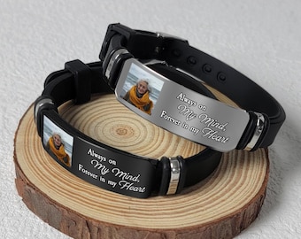 May include: Two black silicone bracelets with silver metal accents. Each bracelet features a photo insert and the text "Always on My Mind. Forever in my Heart."