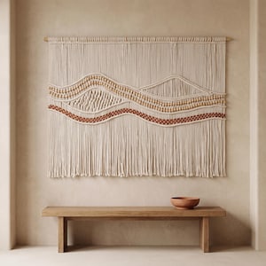 May include: A large macrame wall hanging featuring off-white cotton cord suspended from a wooden dowel. The design incorporates wavy patterns with natural wooden beads and a distinct row of terracotta-colored knots, finished with long fringe.