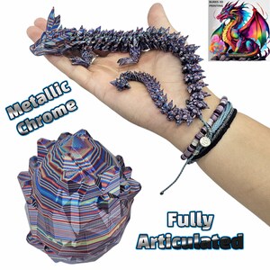 May include: A metallic chrome dragon figurine with a spiky, textured surface. The dragon is fully articulated and posed in a curled position. The dragon is sitting on a hand, and a smaller, spiky, metallic chrome sphere is in the foreground. The text "Metallic Chrome" is in the background. The text "Fully Articulated" is in the foreground.