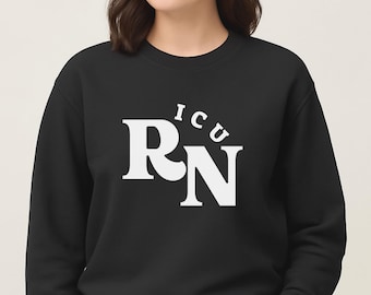 May include: Black crewneck sweatshirt with the white text "ICU RN" printed on the front. The letters are in a bold, sans-serif font. The sweatshirt is a solid black color.
