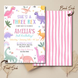 May include: A birthday invitation with a dinosaur theme. The front features colorful dinosaur illustrations and the text "She's a Three Rex" and "Amelia's 3rd birthday!". The back has pink and white vertical stripes.