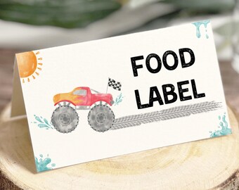 May include: A folded food label featuring a watercolour illustration of a red and orange monster truck. The text "FOOD LABEL" is printed in bold black letters. The design includes a sun and water splashes. Ideal for a party.
