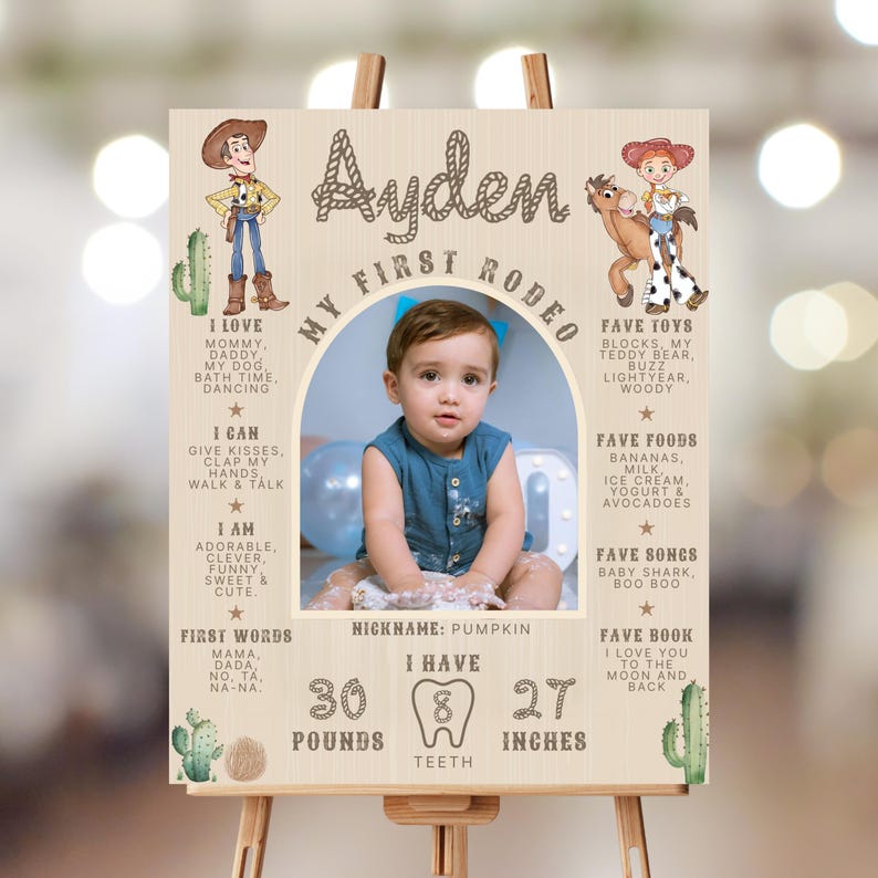 May include: A wooden sign with a photo of a baby boy, cowboy and cowgirl illustrations, and text. The sign says "My First Rodeo" and includes the baby's name, favorite things, and measurements: 13.6 kg, 8 teeth, and 68.6 cm.