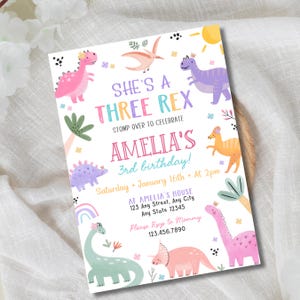 May include: A colorful birthday invitation with a dinosaur theme. The text reads "She's a Three Rex" and "Amelia's 3rd birthday!" with details for the party. The design includes various dinosaurs, a rainbow, and palm trees in pastel colors.