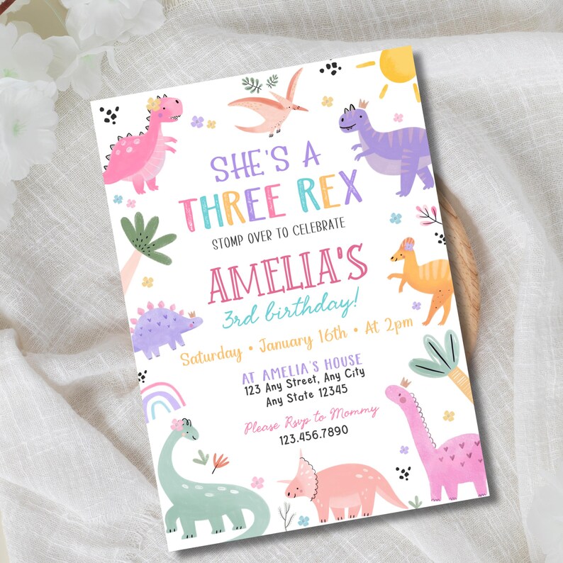 May include: A colorful birthday invitation with a dinosaur theme. The text reads "She's a Three Rex" and "Amelia's 3rd birthday!" with details for the party. The design includes various dinosaurs, a rainbow, and palm trees in pastel colors.