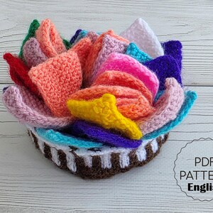 Brightly colored knitted flower mats folded together and stored inside a small handknit basket.