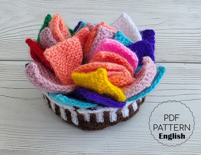 Brightly colored knitted flower mats folded together and stored inside a small handknit basket.