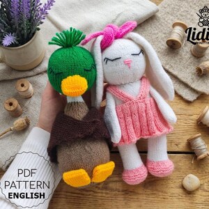 May include: A knitted mallard duck toy with a green head, yellow beak, and brown body next to a white knitted rabbit toy with long ears, a pink bow, and a pink dress. The text Lidiia Knitting Toys and PDF Pattern English are visible.