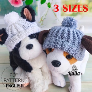 May include: Two plush dog toys wearing knitted hats. One dog wears a white hat with a pom-pom, the other a blue hat with a pom-pom. The image includes the text "3 SIZES" and "PDF PATTERN ENGLISH".