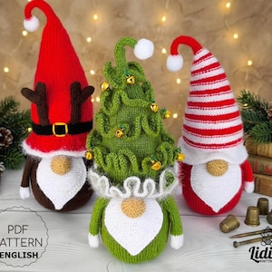 May include: Three handmade Christmas gnomes. One gnome is red with antlers, a black belt, and a white beard. Another is green and shaped like a Christmas tree with gold bells. The third is red and white striped with a white beard. The image includes the text "PDF PATTERN ENGLISH".