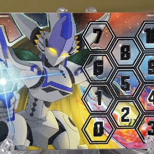 May include: A white and blue robot character with a yellow glowing face is holding a blue and white weapon. The background is a colorful galaxy with a honeycomb grid of numbers 0 through 10.