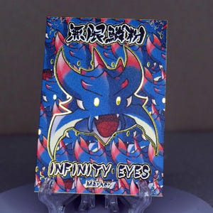 May include: A blue and red cartoon monster with gold accents and the text "INFINITY EYES" and "Marker" on a card. The monster has large eyes and a wide open mouth.