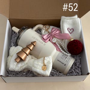 Holiday Best Friend Tumbler Gift Set For Her 
Includes:
30 oz Cream Stanley Flip Top
Initial Tumbler Handle Charm
Pink Bow Pearl Keychain
Fuzzy Heart Socks
Red Velvet Ornament
Spa Headband
Gold Christmas Tree