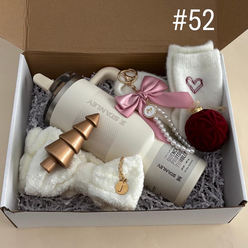 Holiday Best Friend Tumbler Gift Set For Her 
Includes:
30 oz Cream Stanley Flip Top
Initial Tumbler Handle Charm
Pink Bow Pearl Keychain
Fuzzy Heart Socks
Red Velvet Ornament
Spa Headband
Gold Christmas Tree