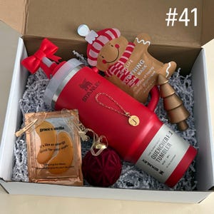 Customizable Gift Box 
Includes:
30 oz Red Stanley
Straw Topper
Initial Tumbler Handle Charm
Xmas Face Mask
Gold Christmas Tree
Eye Mask
Hair Clips
Red Velvet Ornament