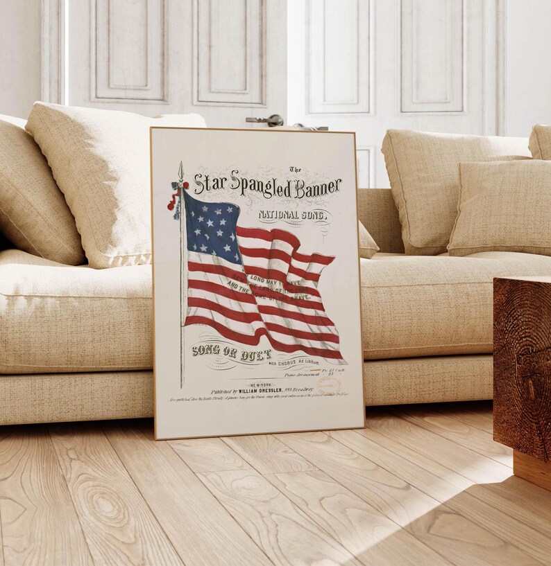 A vintage american flag printable wall art print of the star spangled banner song cover. This print features an american flag blowing in the wind. A patriotic red white and blue print to honor the usa for the 4th of july / independence day. This print is offered as a digital download printable wall art.