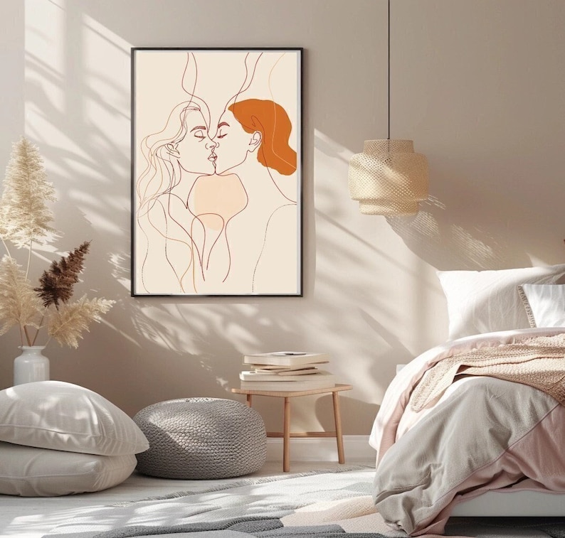 May include: A line art print of two people kissing. The print is in shades of brown and orange and is set against a cream background.