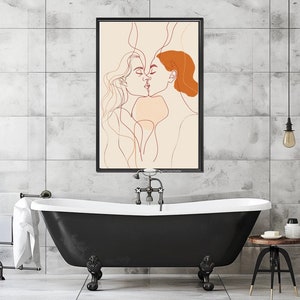 May include: A black and white line drawing of two people kissing. The drawing is framed and hanging on a white tiled wall above a black bathtub.
