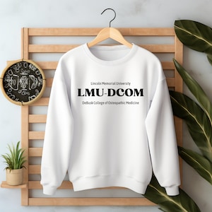 May include: White sweatshirt with black text that reads "Lincoln Memorial University LMU-DCOM DeBusk College of Osteopathic Medicine"