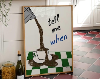May include: A rectangular framed wall art print featuring a graphic illustration of a grey pitcher pouring dark brown liquid into a white coffee cup on a green and white checkered surface, with the black and blue text "tell me when" printed.