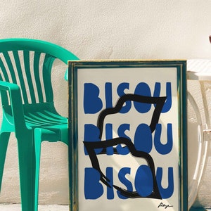 Op de afbeelding: Een ingelijst drukwerk met het woord "BISOU" dat drie keer wordt herhaald in een vet, blauw lettertype. Het woord is gelaagd en gedeeltelijk bedekt met zwarte lijnen, wat een dynamisch en abstract ontwerp cre&euml;ert. De print is rechtsonder gesigneerd.