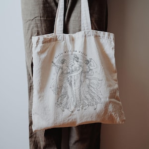 May include: A set of three ceramic mugs with a speckled, matte finish. The mugs are in shades of cream, light gray, and dark gray. Each mug has a simple, minimalist design, perfect for coffee or tea.