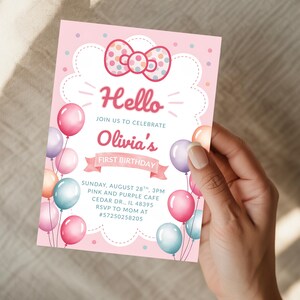 May include: Pink and white birthday invitation with a bow and balloons. The invitation says "Hello" and "Olivia's First Birthday". The invitation includes the date, time, and location of the party.