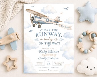 Puede incluir: Una tarjeta de invitación para baby shower con una ilustración en acuarela de un avión vintage azul y crema que lleva una pancarta que dice OH BOY! El texto dice CLEAR THE RUNWAY, a baby is ON THE WAY! con los detalles para Emily Johnson.