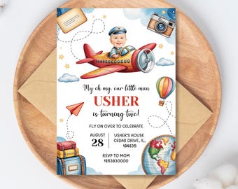 May include: A watercolor-style invitation with a red and yellow airplane, a baby wearing a pilot hat, and the text "My oh my, our little man USHER is turning two!" Additional elements include a hot air balloon, a camera, and a world map.