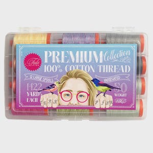 May include: A clear plastic storage case containing 12 large spools of 50 weight 100% cotton thread. The label features the text Premium Collection, 1422 yards each, and an illustration of a person wearing pink glasses with birds on their hands.