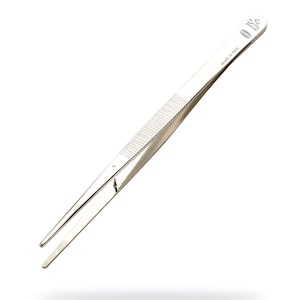 May include: Silver-toned tweezers with a textured grip and a pointed tip. The tweezers are 11.5 cm long and have the text "Made in Italy" and "01/2" printed on the side.