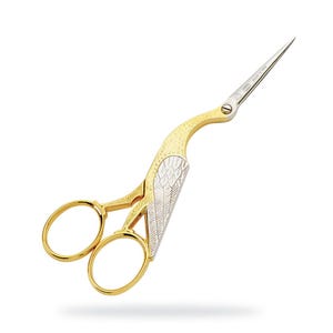 May include: Gold and silver decorative scissors with a bird-like design. The scissors have a pointed tip and two round loops.