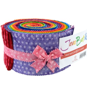 May include: A rolled bundle of colorful fabric strips, featuring a rainbow of hues at the center. The outer layer is purple with white polka dots, secured with a pink ribbon and bow. The label reads "Java Batik" and "Maywood Studio".