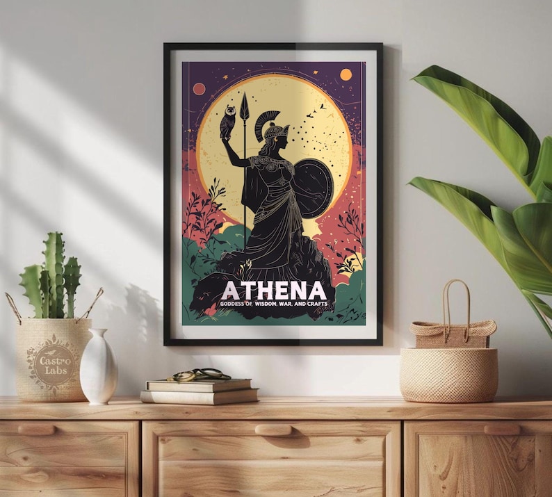 Framed poster of Athena, goddess of wisdom, war, and crafts, displayed on a modern wall with a potted plant.